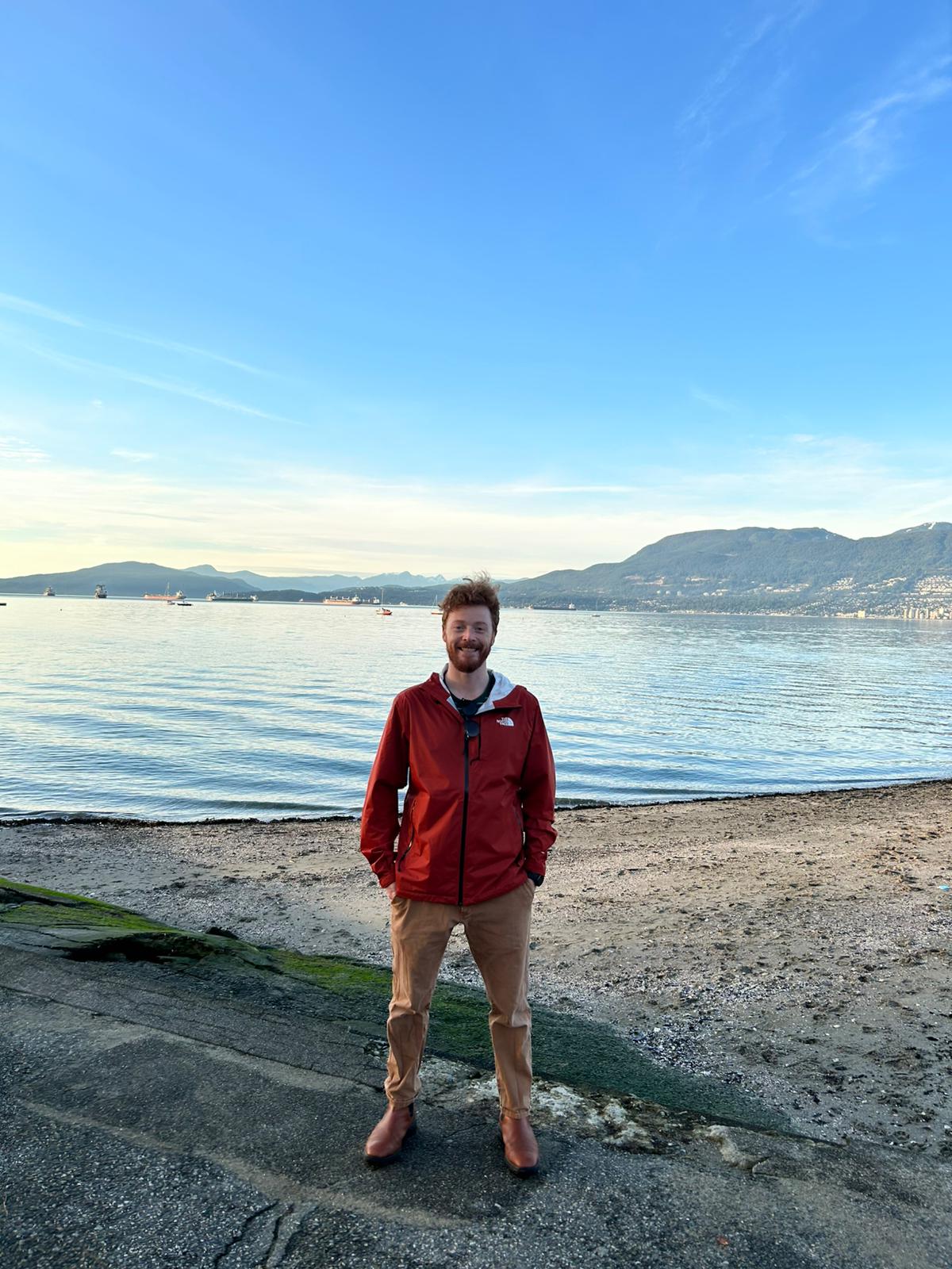 Eric Laycock on the beach with mountains in the background